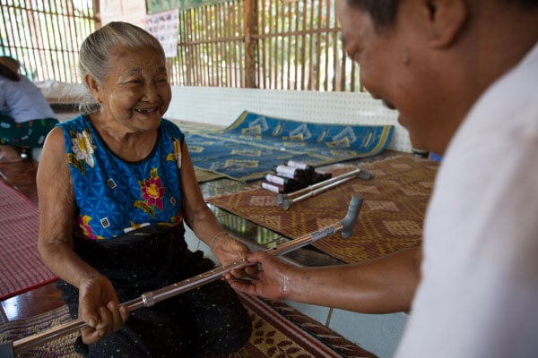 Daw Mya Ichin Phone, 81, from Myanmar collects her walking stick. Taken by Hereward Holland